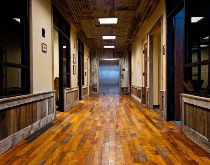 An elevator at the end of a reclaimed hardwood flooring corridor at the Harley Davidson showroom In Southaven, MS