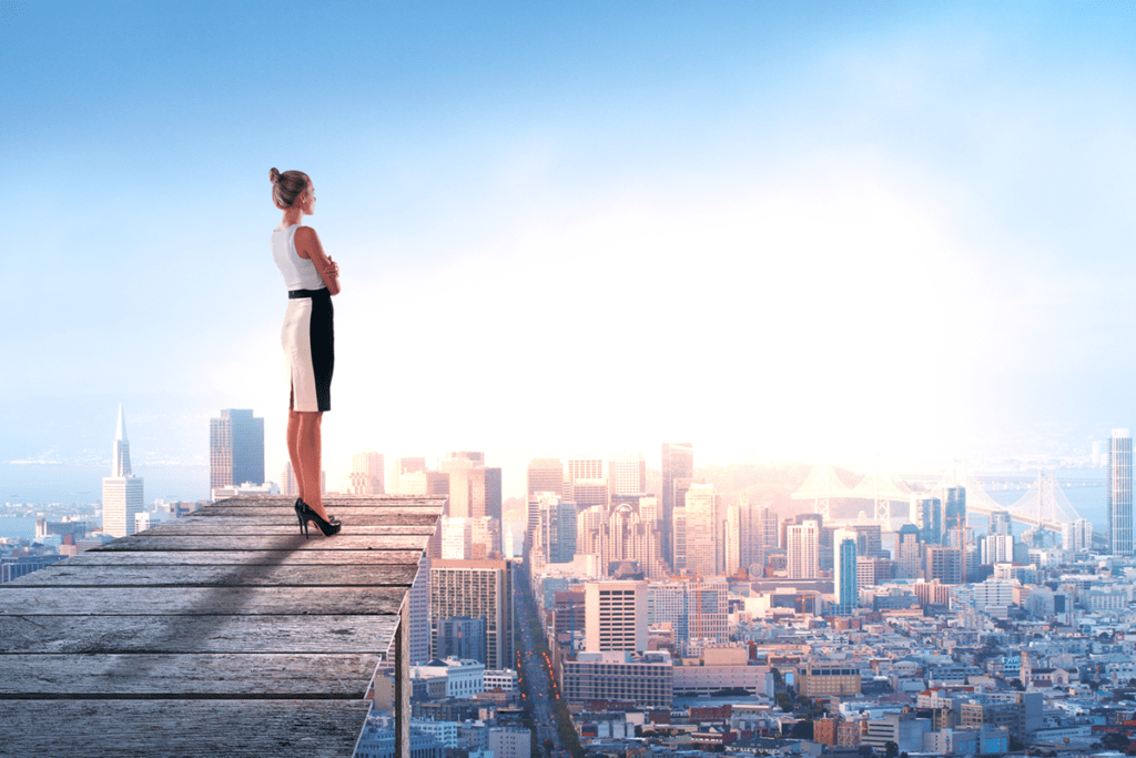 woman standing on wooden board and looking to the future