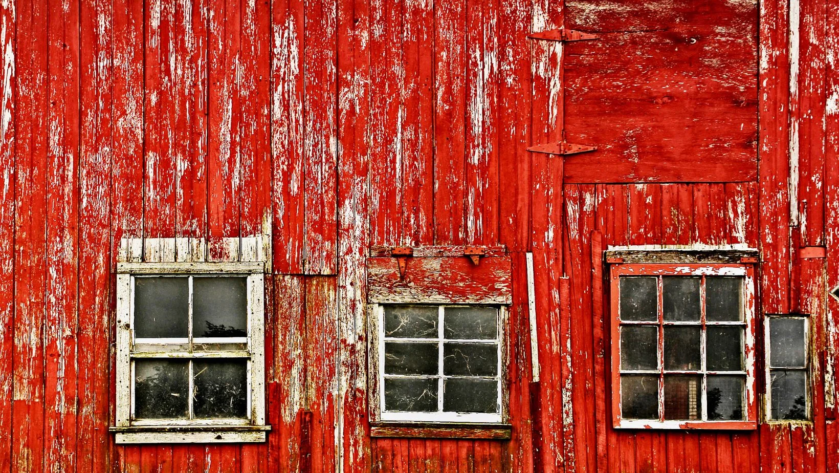 A closeup of an old red barn