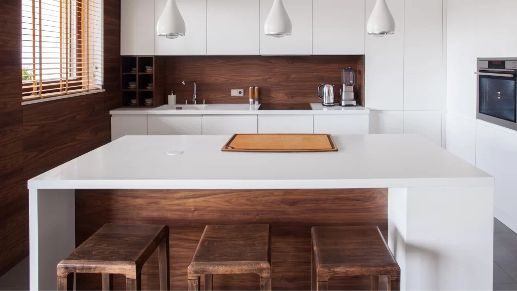 A white kitchen island in modern and wooden kitchen