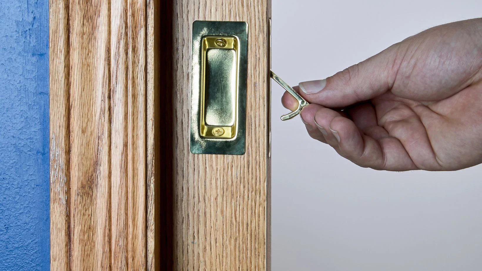 a male hand reaching for a concealed pocket door