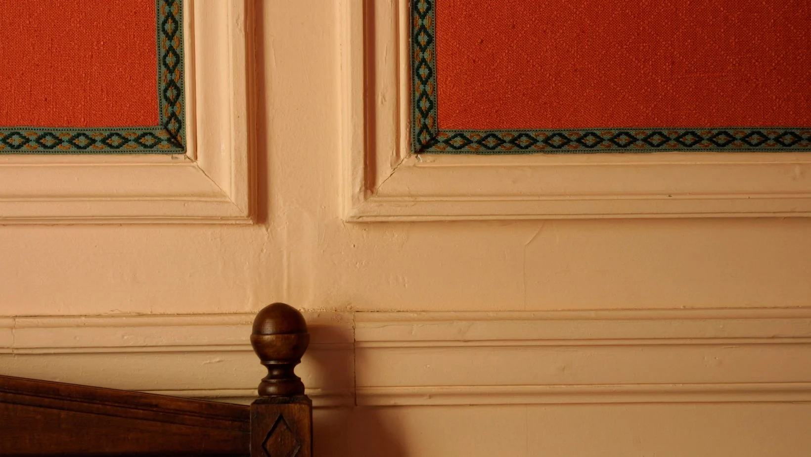 wooden crown molding on red walls