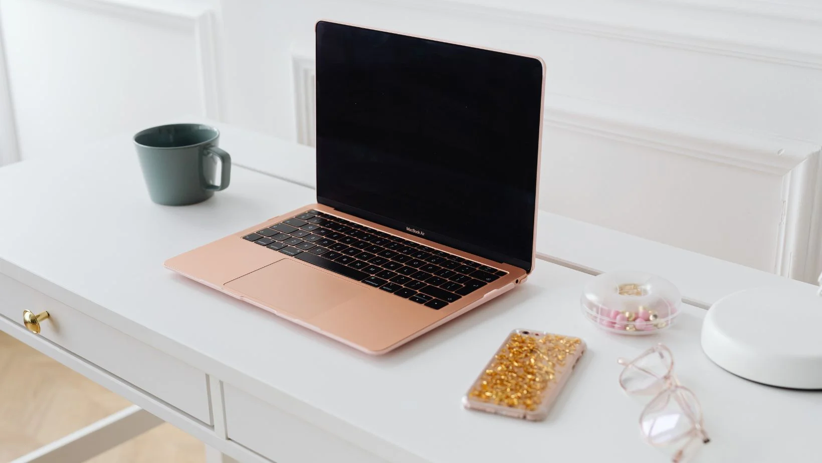 white wooden desk with a laptop